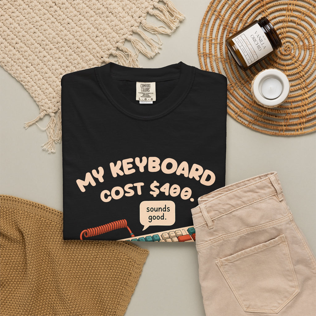 Black My Keyboard Cost $400 tee by Mildly Unavailable laid flat with folded pants and home decor