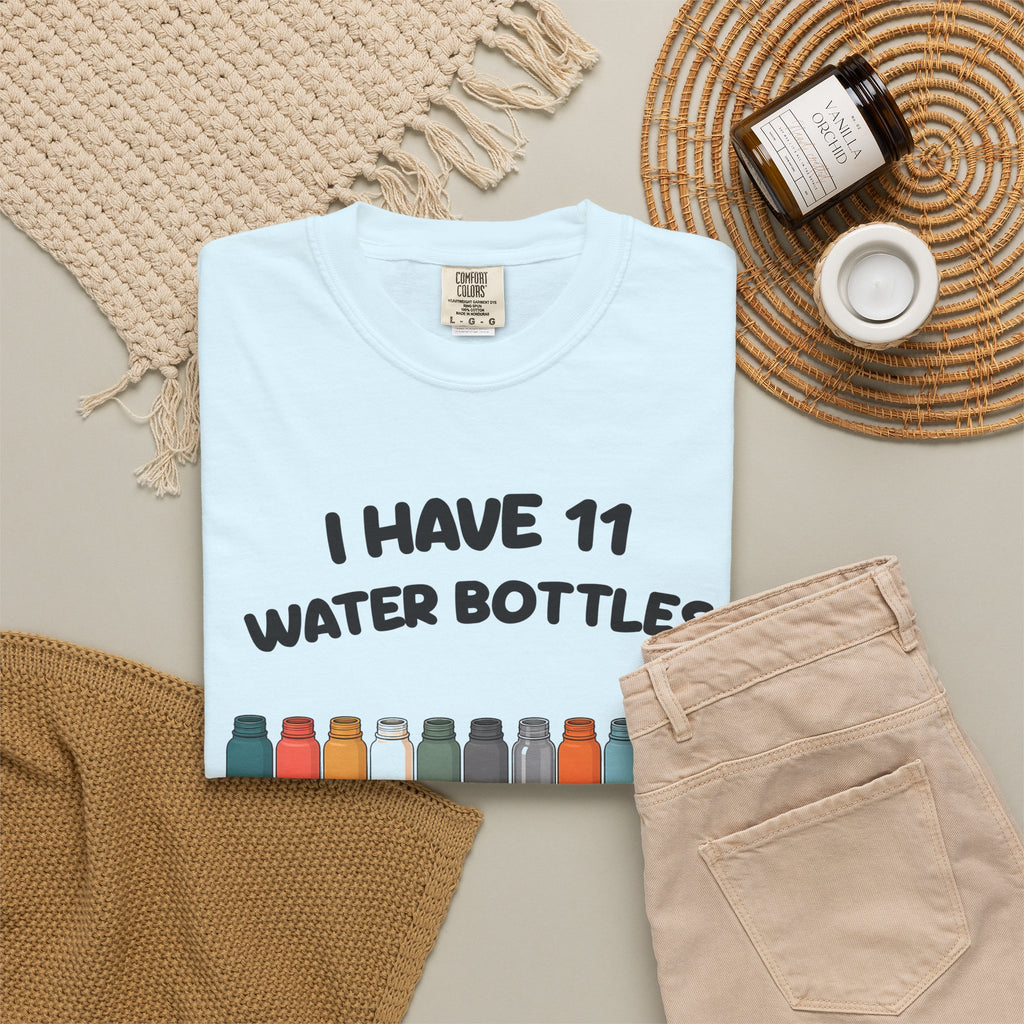 Chambray 11 Water Bottles, No Lids tee by Mildly Unavailable laid flat with folded pants and home decor