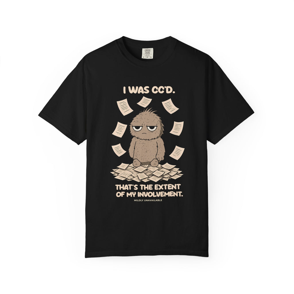 Black tee with the I Was CC'd design: Murray, a grumpy furry little guy, sitting in a pile of paper with the line That's the extent of my involvement, by Mildly Unavailable