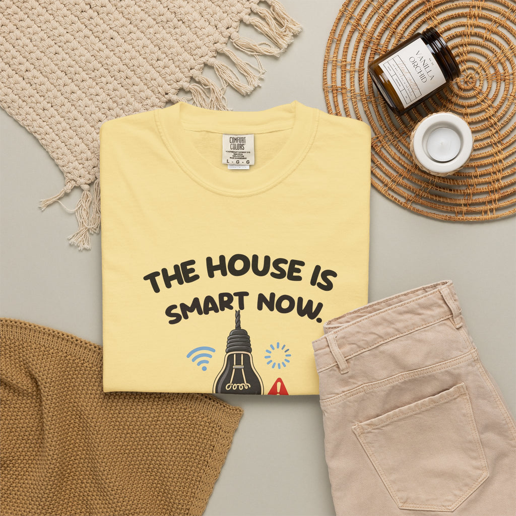 Butter The House Is Smart Now tee by Mildly Unavailable laid flat with folded pants and home decor