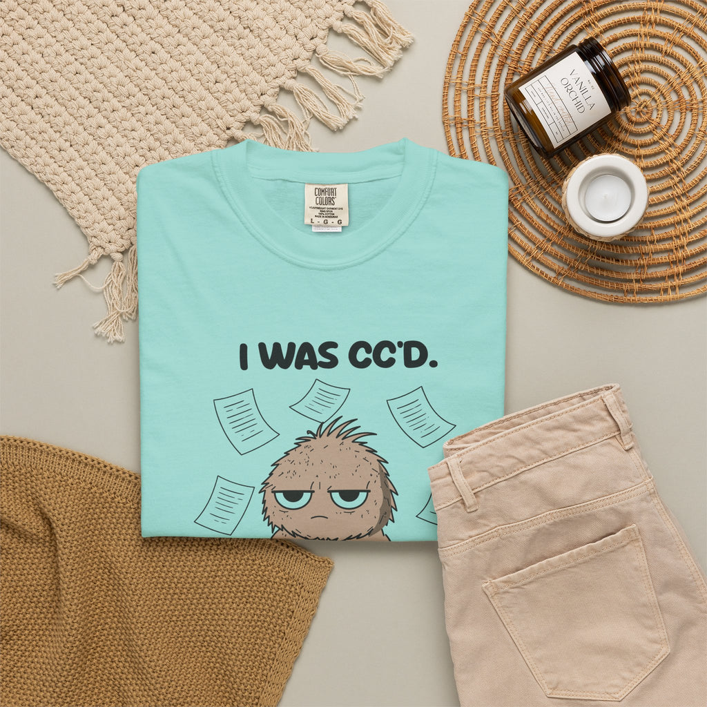 Chalky Mint I Was CC'd Murray tee by Mildly Unavailable laid flat with folded pants and home decor
