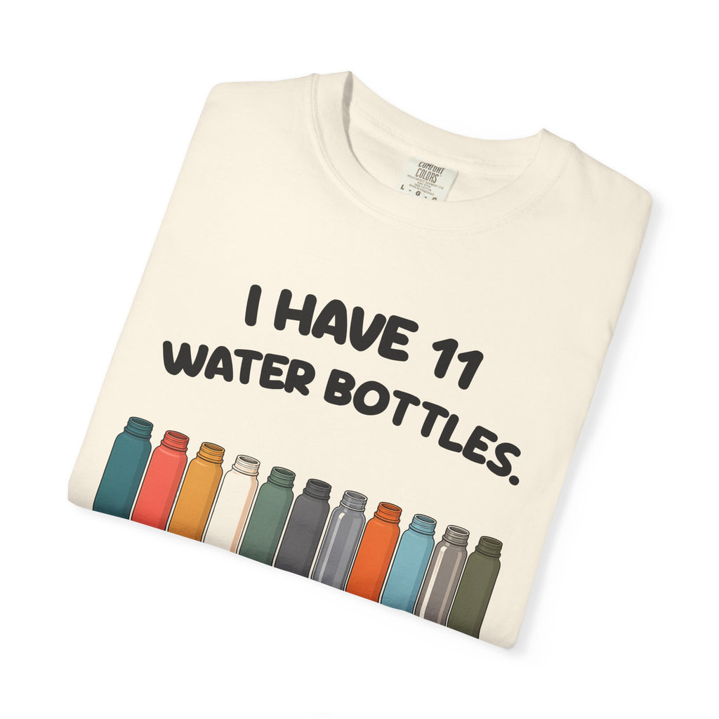 Folded ivory 11 Water Bottles, No Lids tee by Mildly Unavailable, close-up of the front design