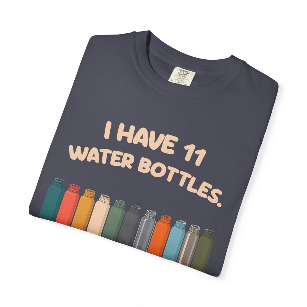 Folded navy 11 Water Bottles, No Lids tee by Mildly Unavailable, close-up of the front design