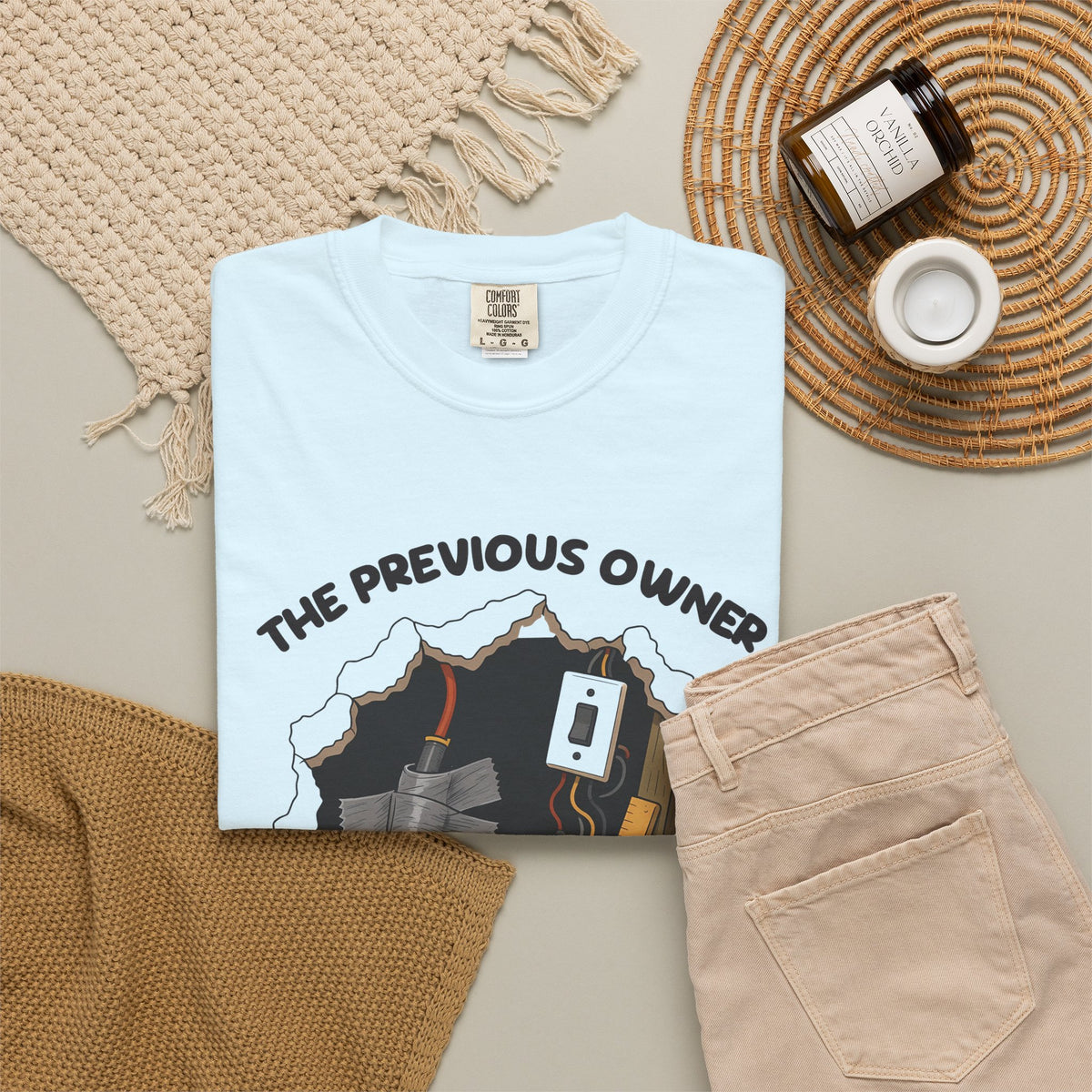 Chambray The Previous Owner Did It Himself tee by Mildly Unavailable laid flat with folded pants and home decor