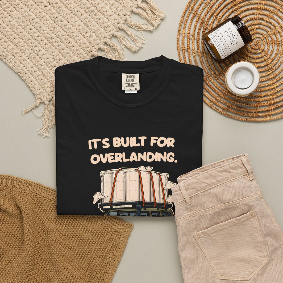 Black Built for Overlanding tee by Mildly Unavailable laid flat with folded pants and home decor