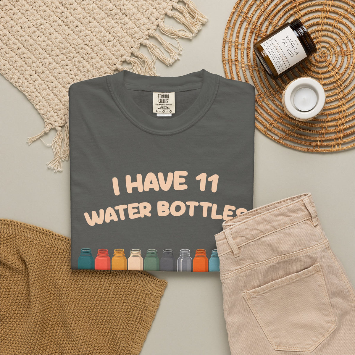 Pepper 11 Water Bottles, No Lids tee by Mildly Unavailable laid flat with folded pants and home decor