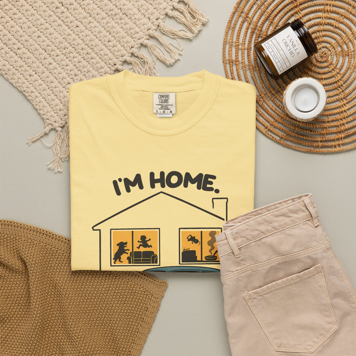 Butter Just Sitting in the Car for a Minute Murray tee by Mildly Unavailable laid flat with folded pants and home decor
