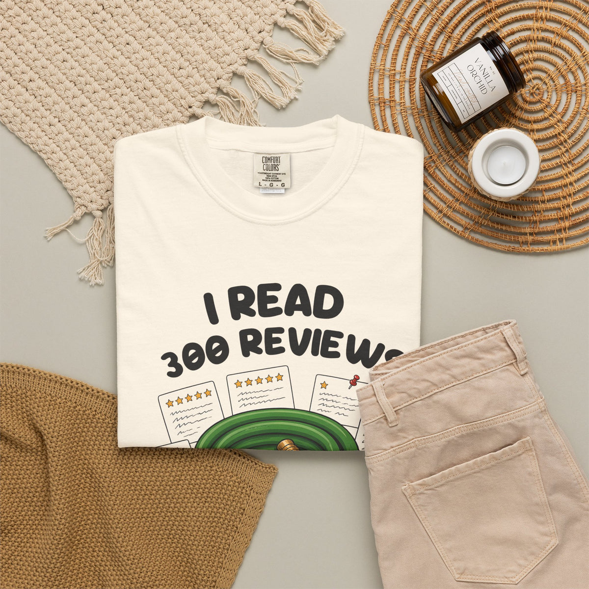 Ivory I Read 300 Reviews for a Garden Hose tee by Mildly Unavailable laid flat with folded pants and home decor