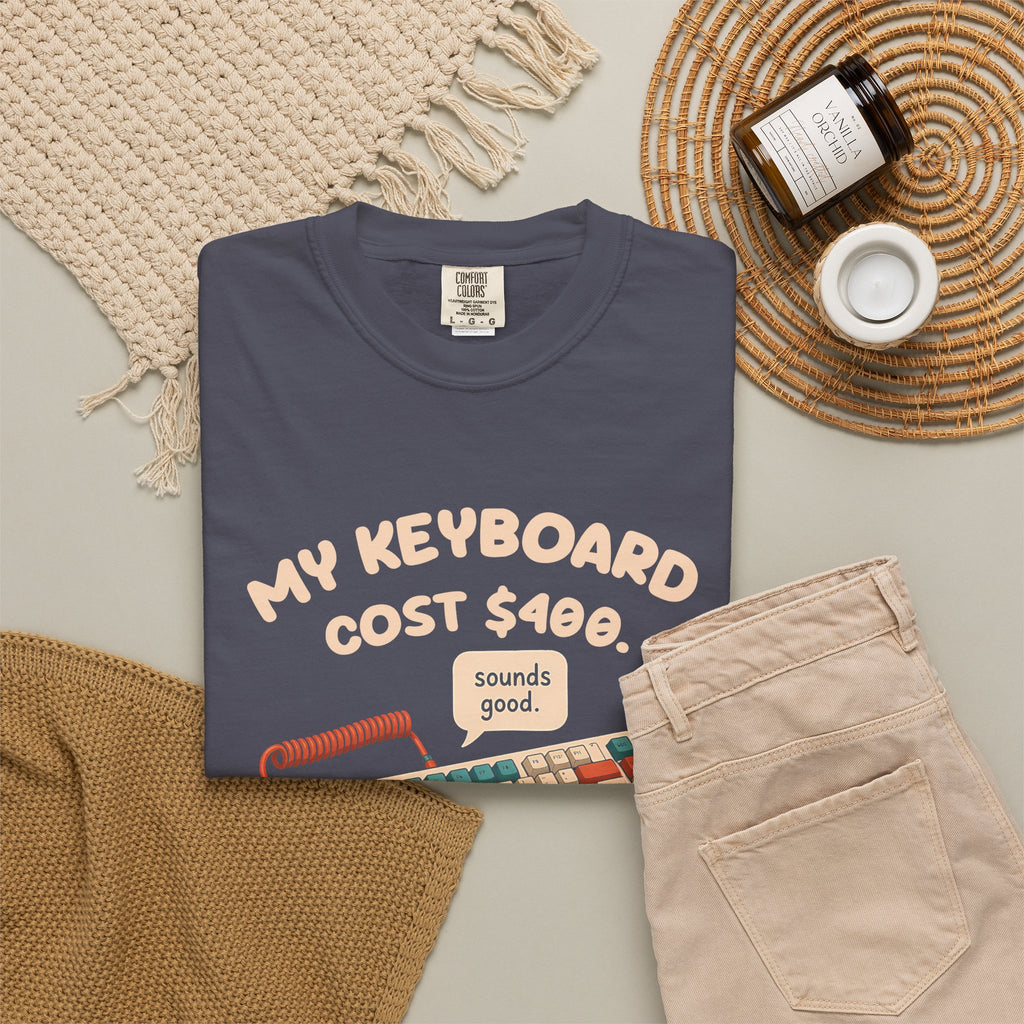 Navy My Keyboard Cost $400 tee by Mildly Unavailable laid flat with folded pants and home decor