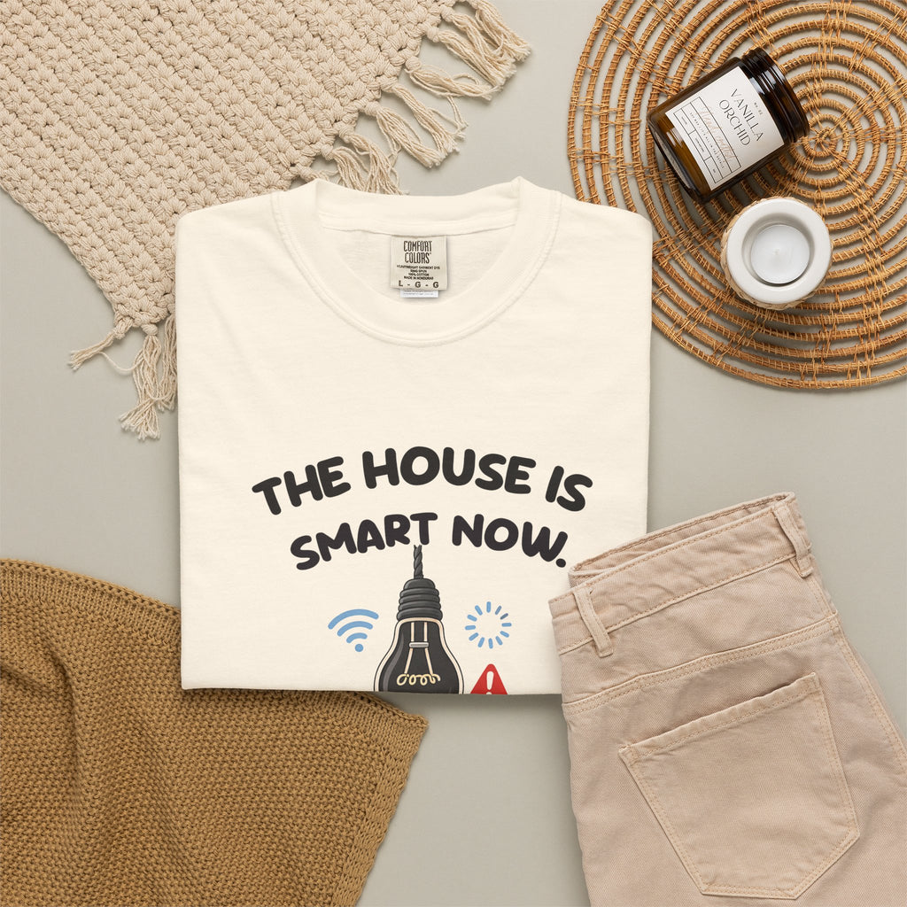 Ivory The House Is Smart Now tee by Mildly Unavailable laid flat with folded pants and home decor