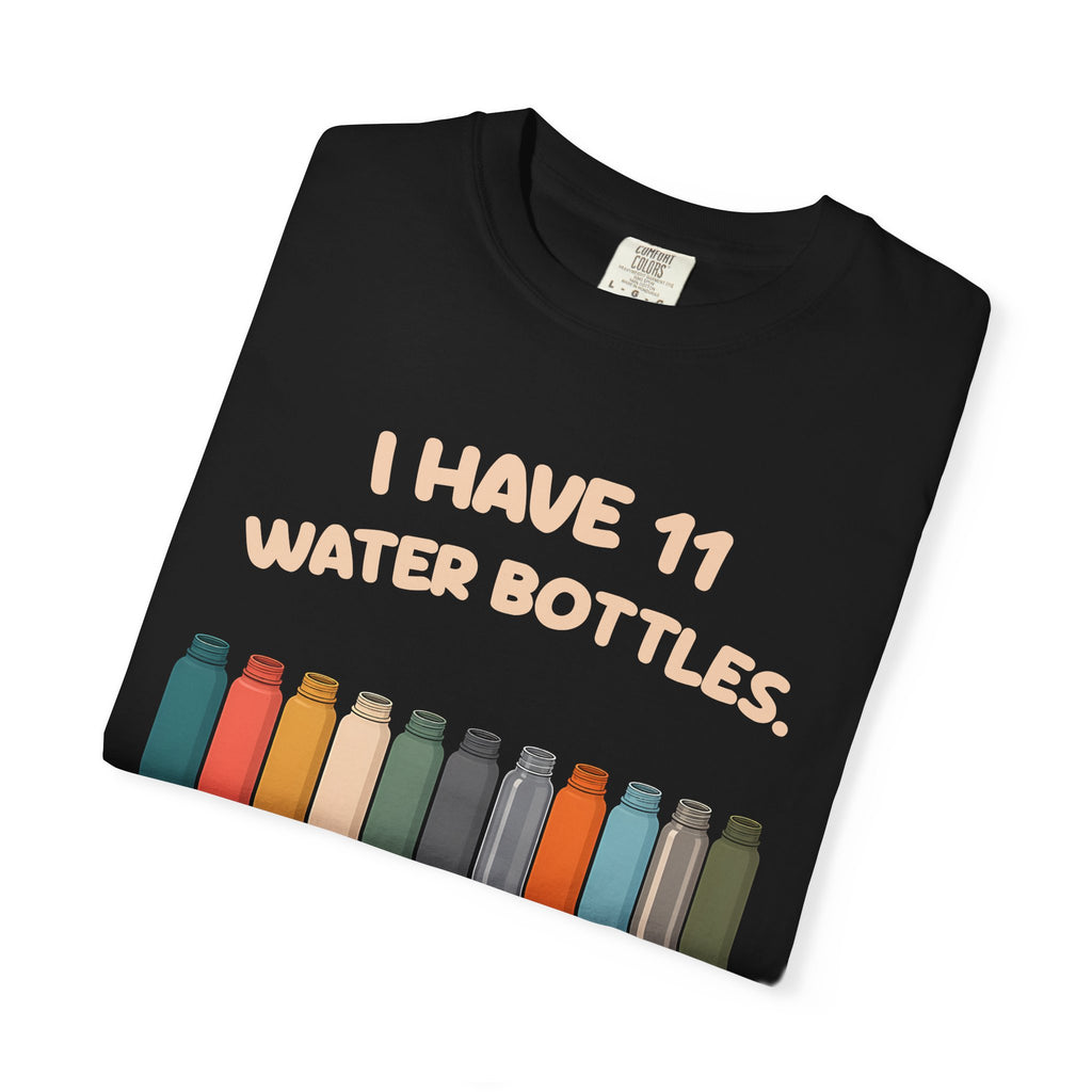 Folded black 11 Water Bottles, No Lids tee by Mildly Unavailable, close-up of the front design