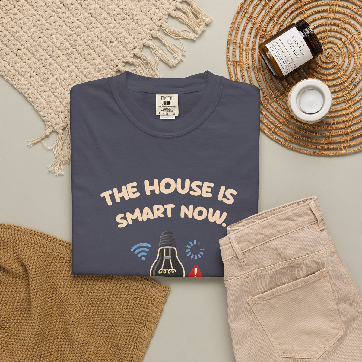 Navy The House Is Smart Now tee by Mildly Unavailable laid flat with folded pants and home decor
