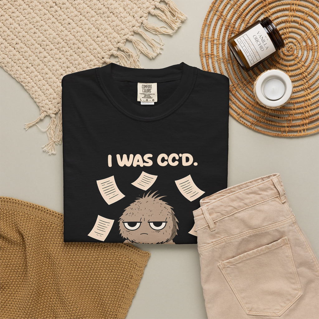 Black I Was CC'd Murray tee by Mildly Unavailable laid flat with folded pants and home decor