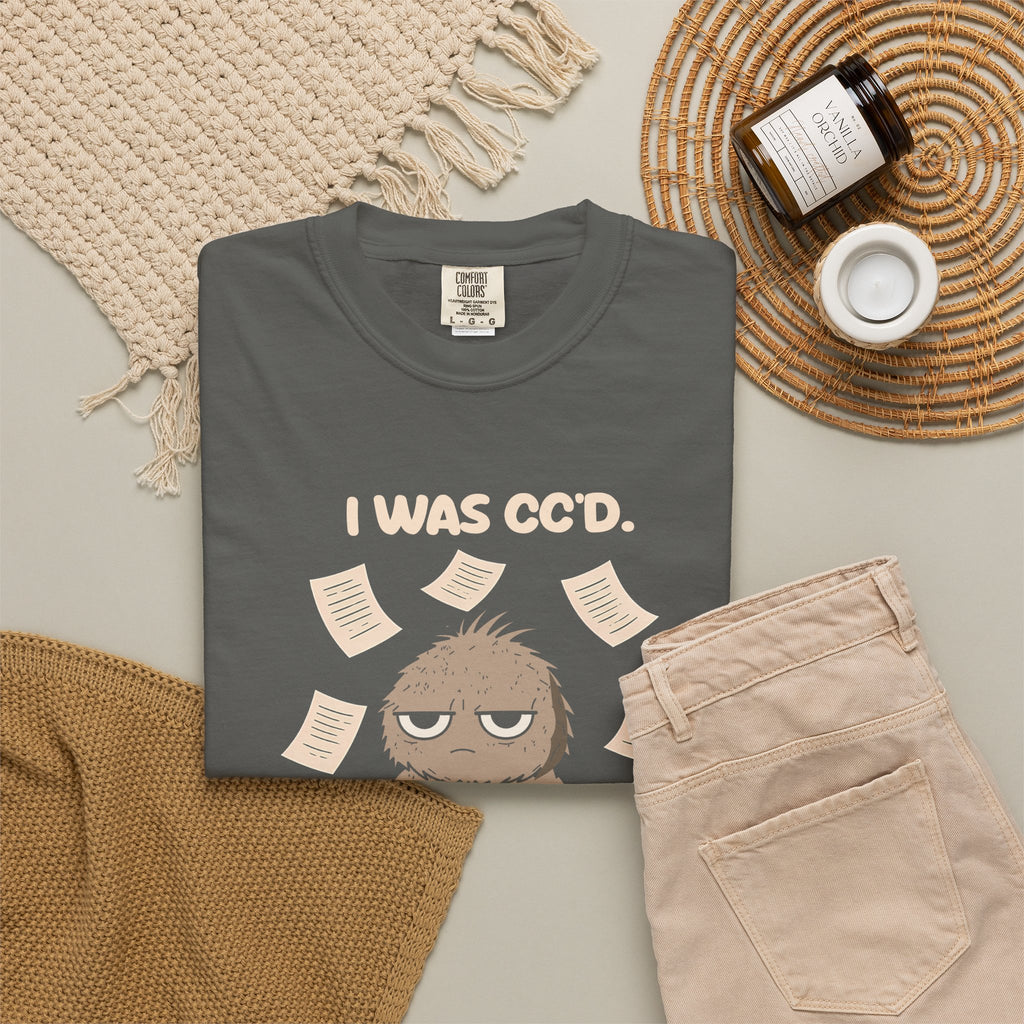 Pepper I Was CC'd Murray tee by Mildly Unavailable laid flat with folded pants and home decor