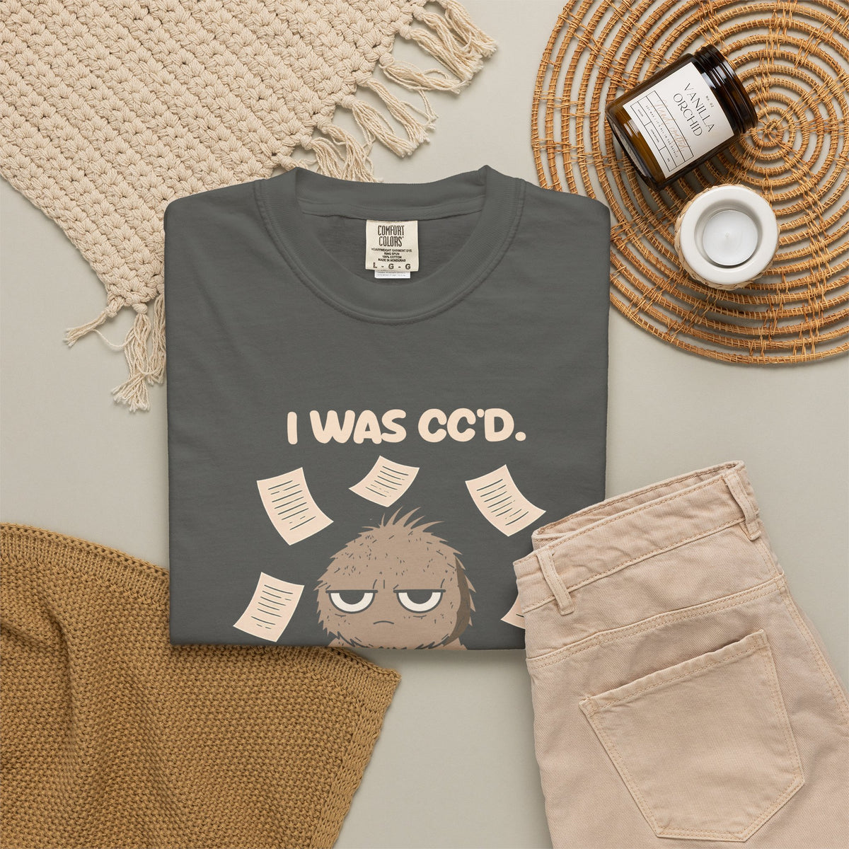 Pepper I Was CC'd Murray tee by Mildly Unavailable laid flat with folded pants and home decor