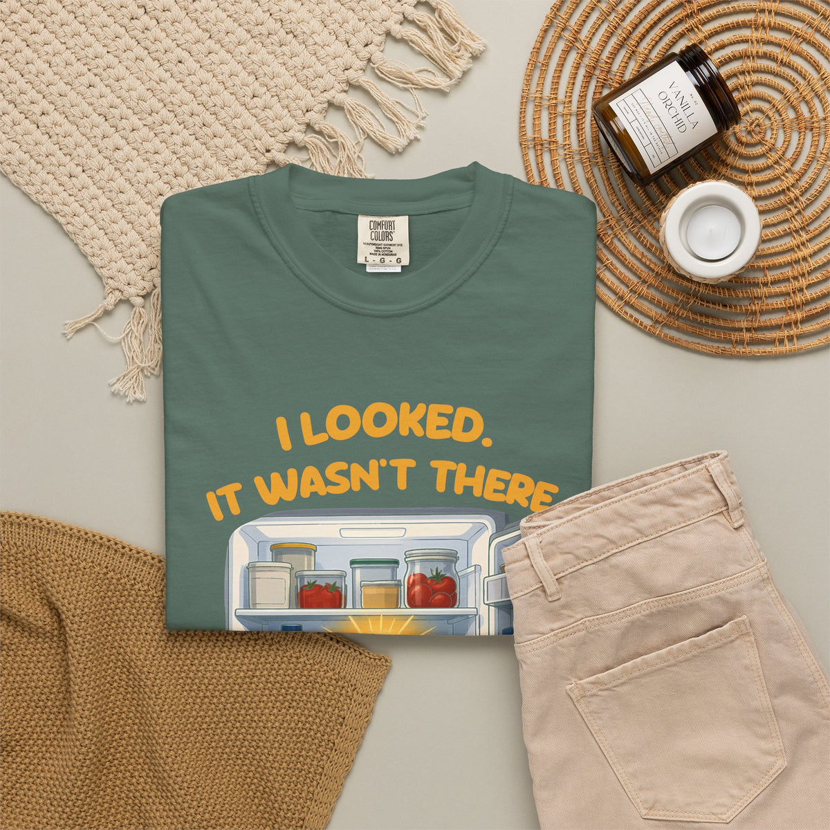 Blue Spruce I Looked. It Wasn't There. It Was There. tee by Mildly Unavailable laid flat with folded pants and home decor
