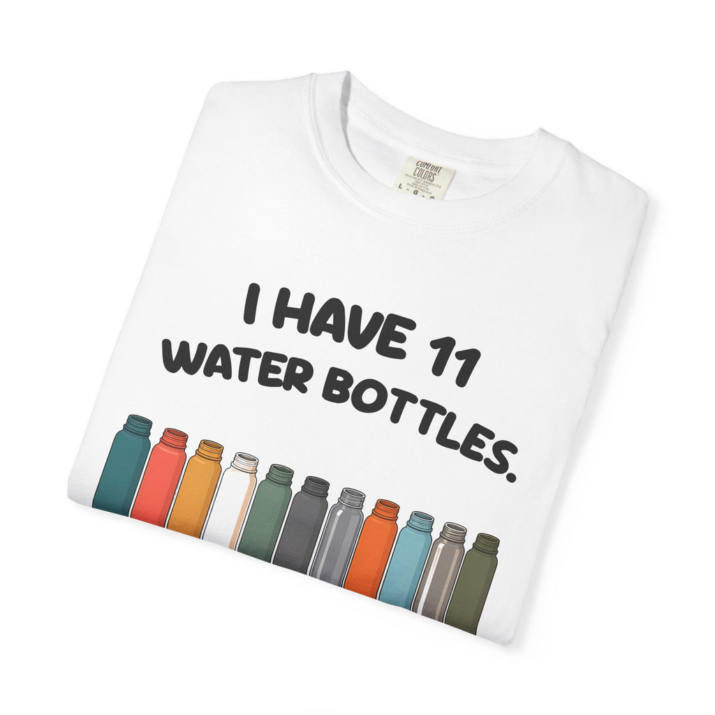 Folded white 11 Water Bottles, No Lids tee by Mildly Unavailable, close-up of the front design