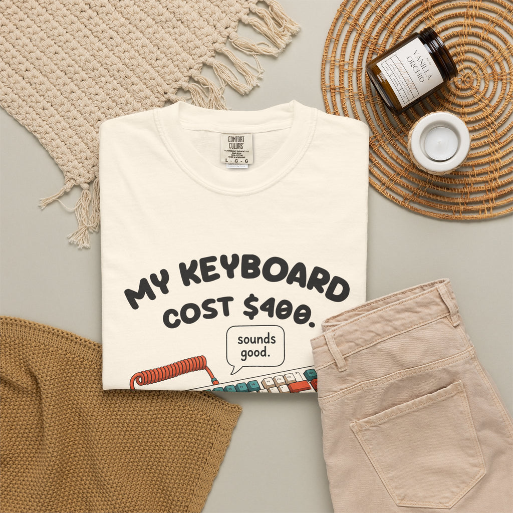 Ivory My Keyboard Cost $400 tee by Mildly Unavailable laid flat with folded pants and home decor