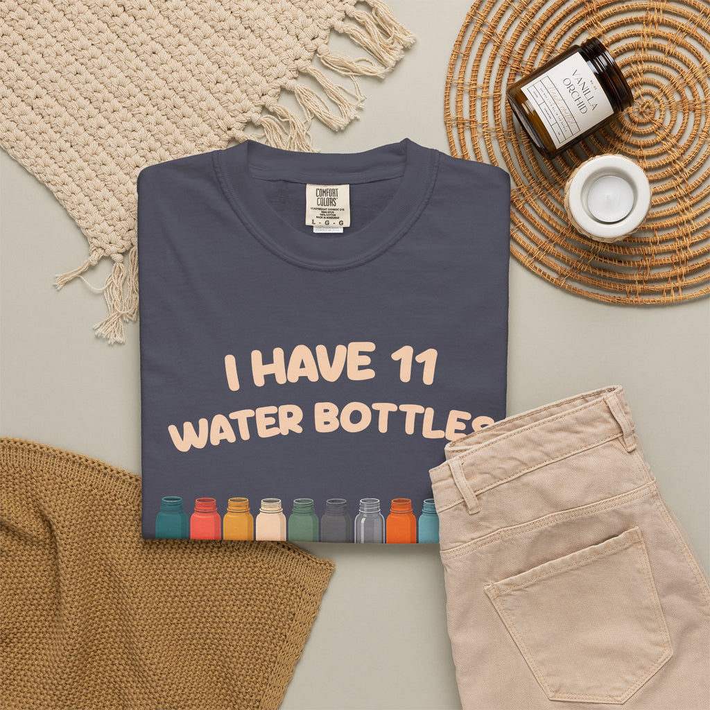 Navy 11 Water Bottles, No Lids tee by Mildly Unavailable laid flat with folded pants and home decor