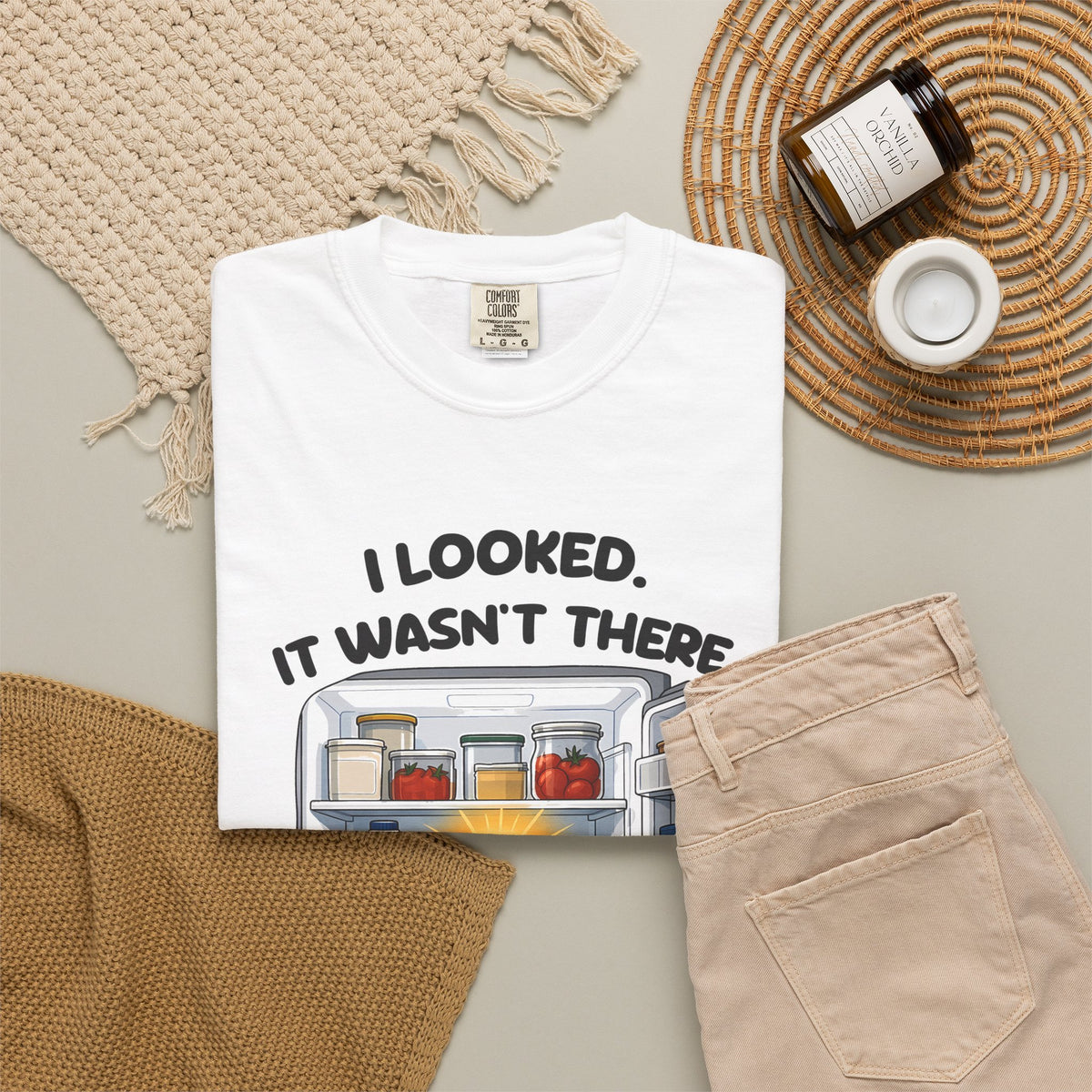 White I Looked. It Wasn't There. It Was There. tee by Mildly Unavailable laid flat with folded pants and home decor