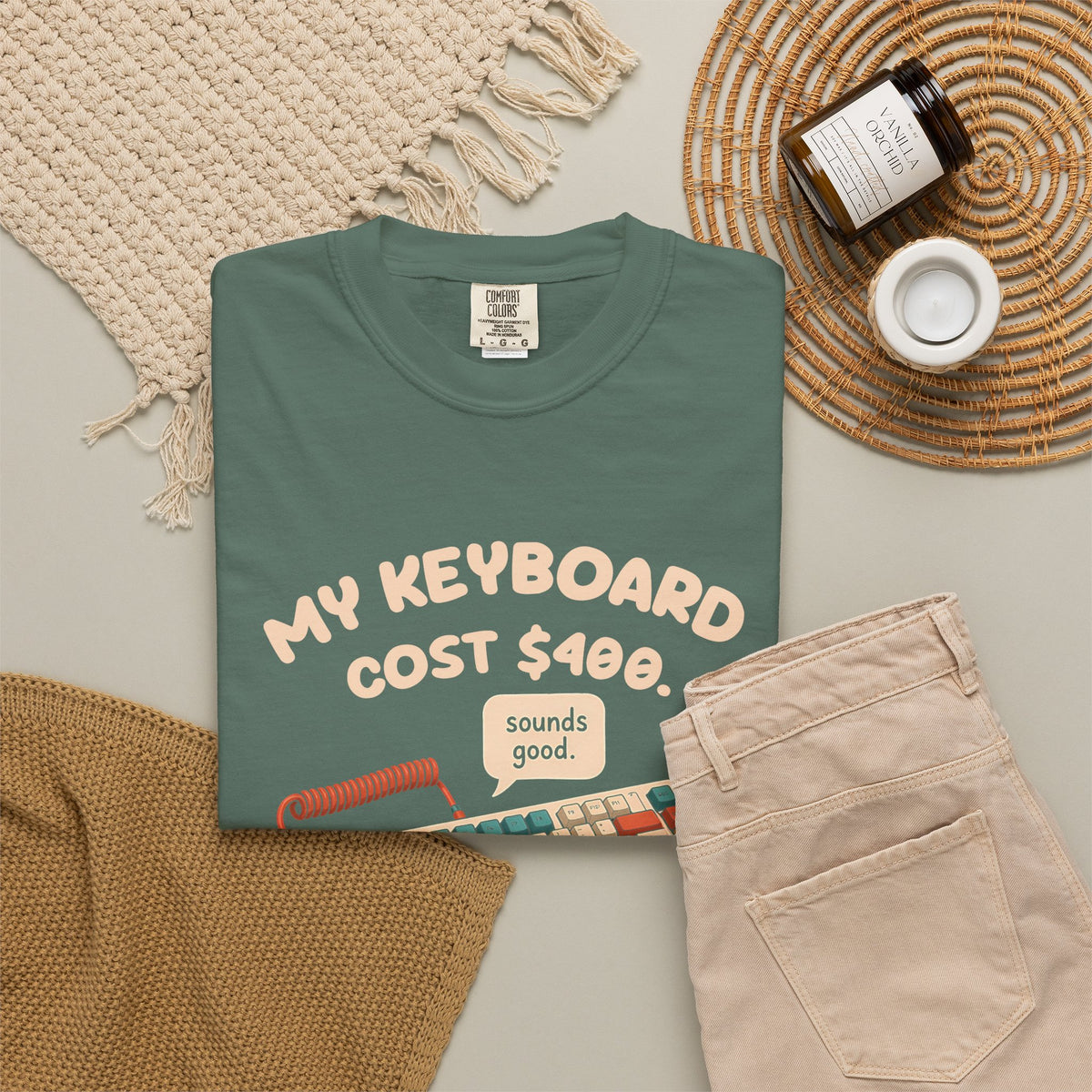 Blue Spruce My Keyboard Cost $400 tee by Mildly Unavailable laid flat with folded pants and home decor