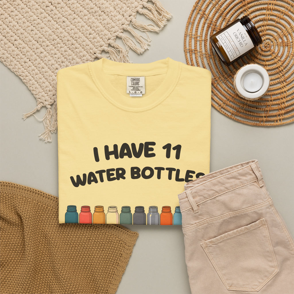 Butter 11 Water Bottles, No Lids tee by Mildly Unavailable laid flat with folded pants and home decor