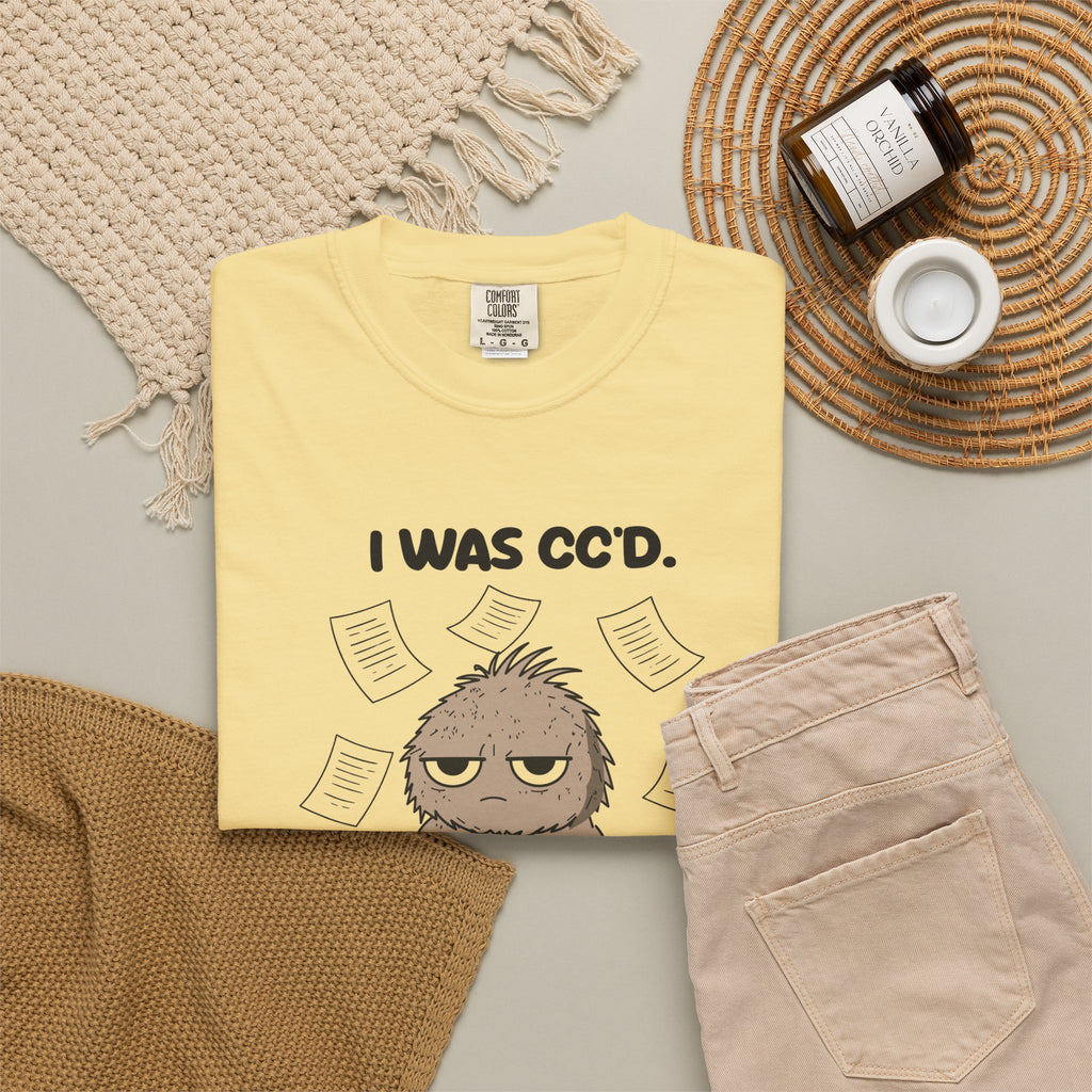 Butter I Was CC'd Murray tee by Mildly Unavailable laid flat with folded pants and home decor