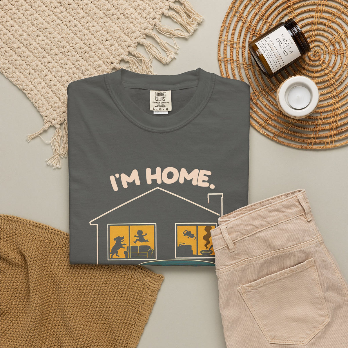 Pepper Just Sitting in the Car for a Minute Murray tee by Mildly Unavailable laid flat with folded pants and home decor