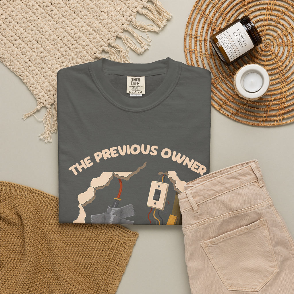 Pepper The Previous Owner Did It Himself tee by Mildly Unavailable laid flat with folded pants and home decor