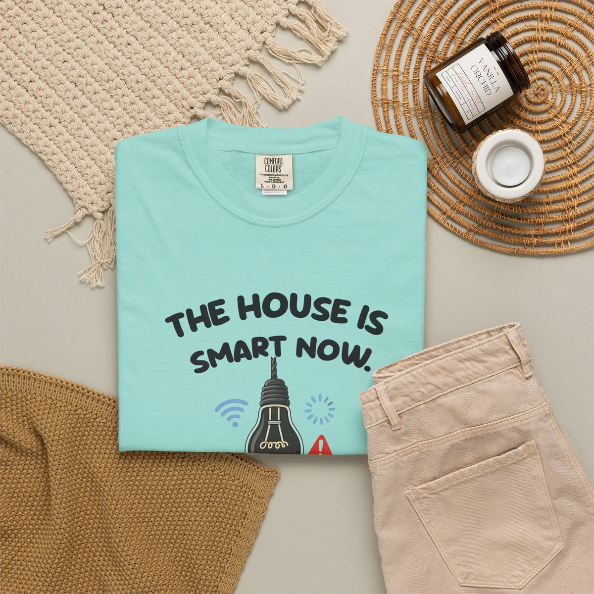 Chalky Mint The House Is Smart Now tee by Mildly Unavailable laid flat with folded pants and home decor