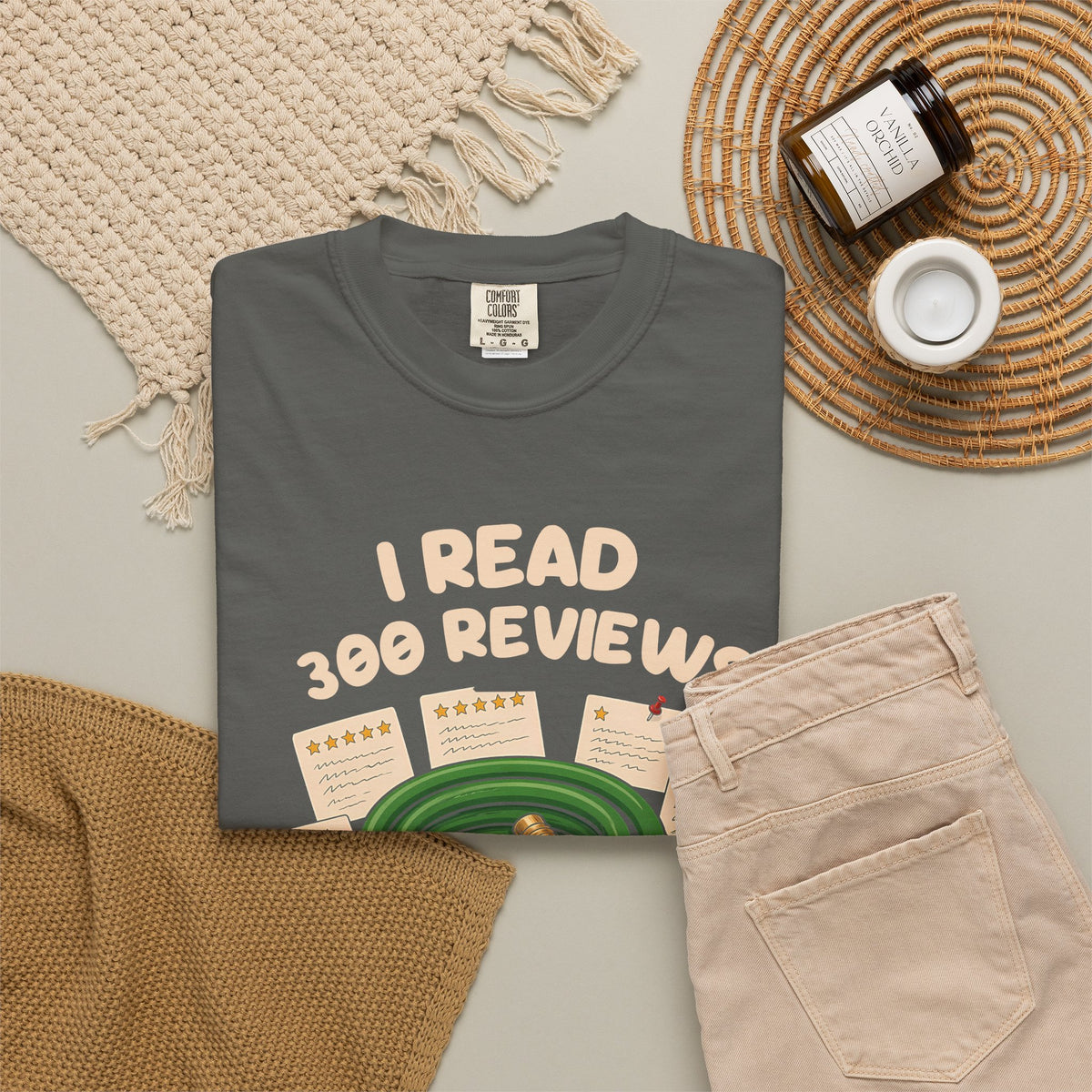 Pepper I Read 300 Reviews for a Garden Hose tee by Mildly Unavailable laid flat with folded pants and home decor