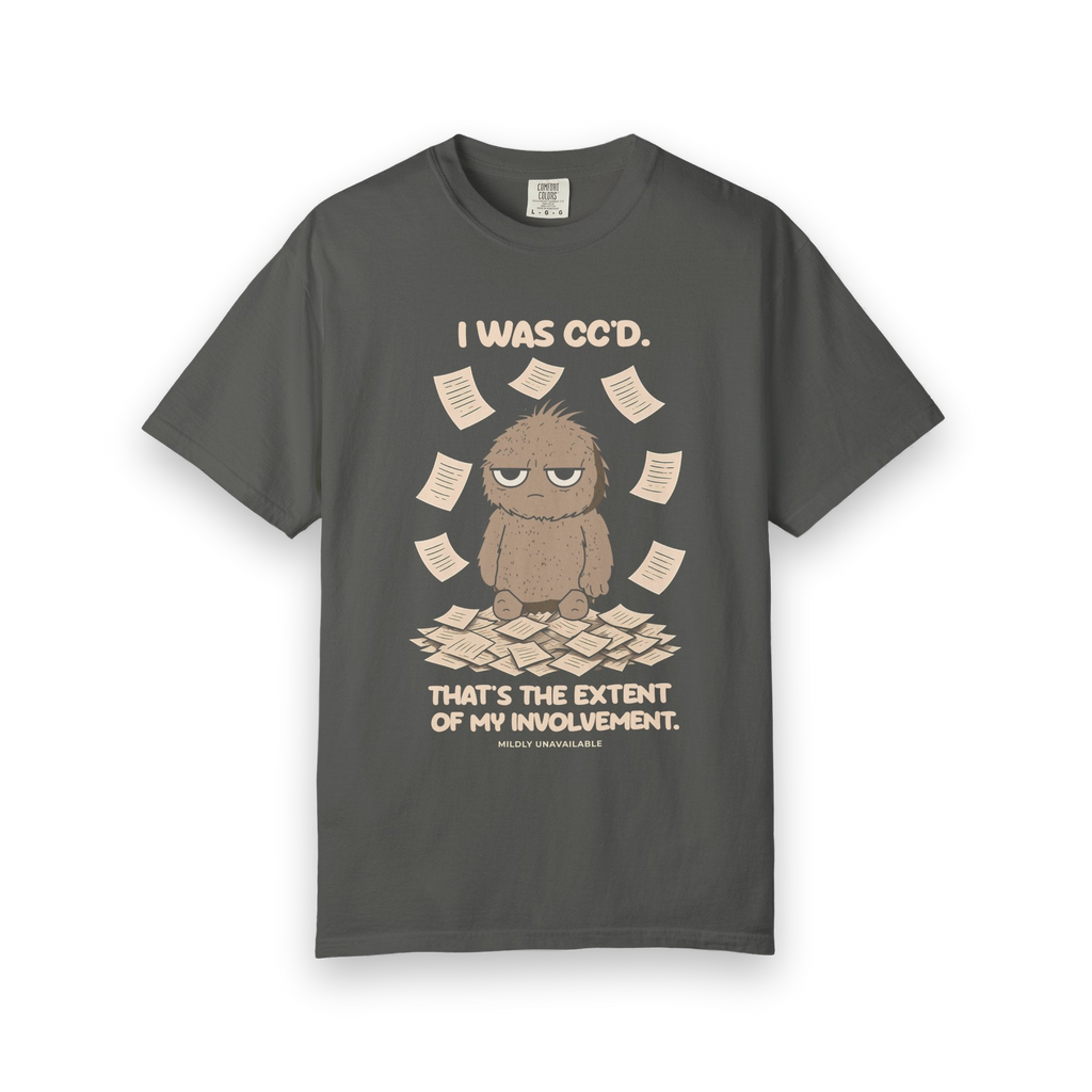 Pepper tee with the I Was CC'd design: Murray, a grumpy furry little guy, sitting in a pile of paper with the line That's the extent of my involvement, by Mildly Unavailable
